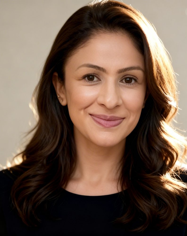 Portrait of Sabina Mustafa, smiling, with long dark wavy hair